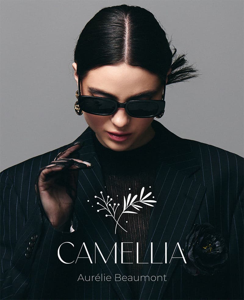 Camellia campaign post, a model in a pinstripe suit under the wordmark